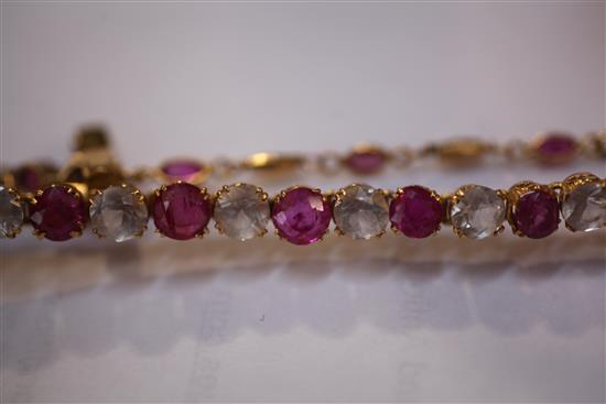 A Middle Eastern high carat gold, ruby and white topaz bracelet, gross weight 17 grams.